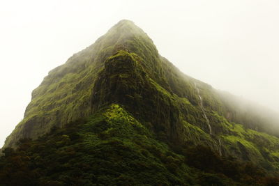 Low angle view of mountain against cloudy sky