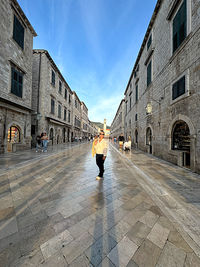 Rear view of woman walking on street