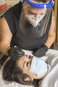 High angle portrait of woman holding hands