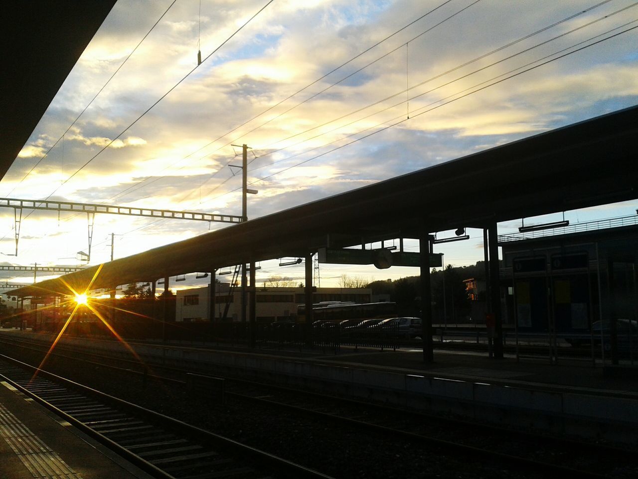 RAILROAD TRACKS AGAINST SKY DURING SUNSET