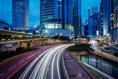 Light trails along buildings on urban street