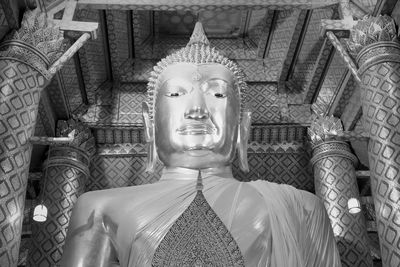 Buddha statue in temple outside building