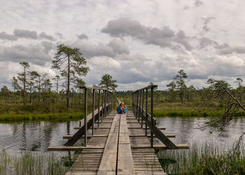 Pier over lake against sky