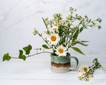 Close-up of white flowers in vase on table