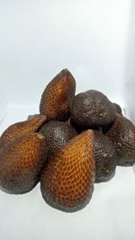 Close-up of fruits on table against white background