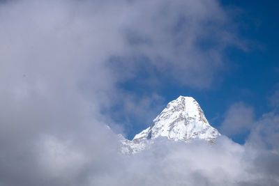 Low angle view of snowcapped mountain against sky