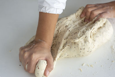 Man kneading a large dough for homemade bread in quarantine