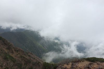 Scenic view of mountains against cloudy sky