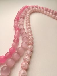 High angle view of pink petals on table against white background