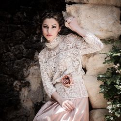 Portrait of young woman against wall