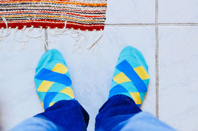 Low section of person wearing socks standing on floor