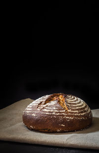 Close-up of cake against black background