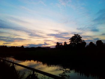 Scenic view of silhouette trees against sky at sunset