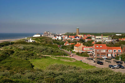 High angle view of buildings and sea against sky