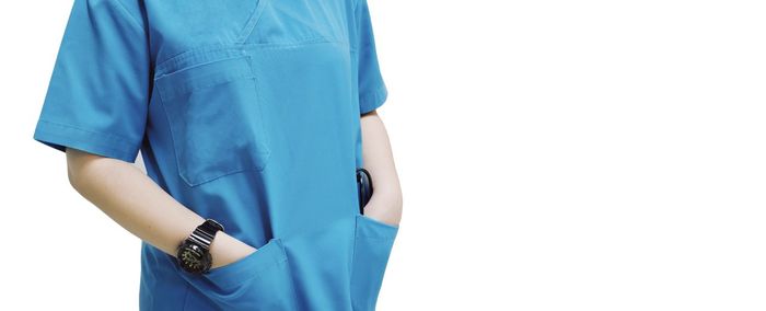 Midsection of woman standing against white background