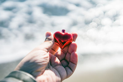 Close-up of hand holding heart shape