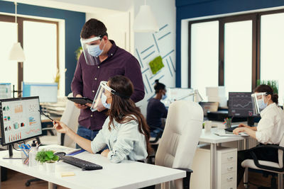 Rear view of business colleagues working at office