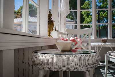 Potted plant on table by window at home