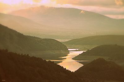 Scenic view of mountains against sky at sunset