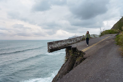 Man standing on sea against sky