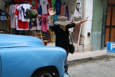 Woman crossing road at market