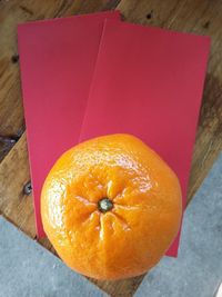 High angle view of orange on paper