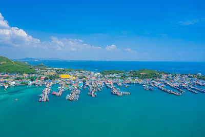 High angle view of boats in sea against blue sky