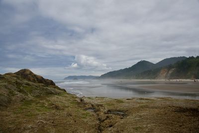 Scenic view of sea and mountains against sky