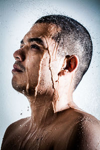 Close-up of young man with wet face