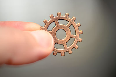 Close-up of hand holding metallic structure