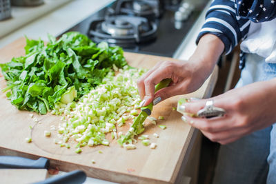 Midsection of woman preparing food at home