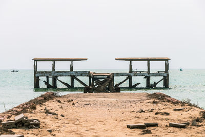 Lifeguard hut on beach against clear sky