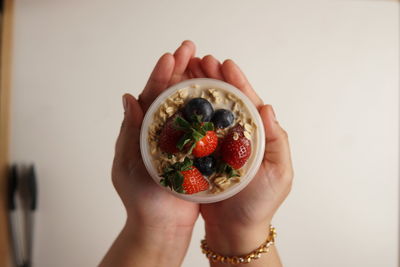 Midsection of woman holding fruits