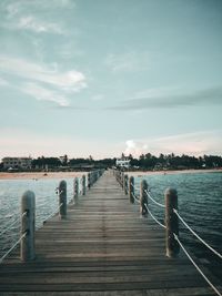 Pier over sea against sky