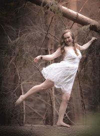 Full length of a young woman in forest