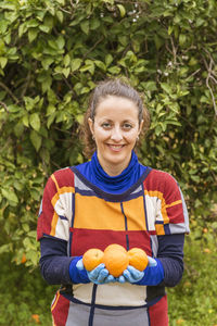 Portrait of smiling young woman standing outdoors