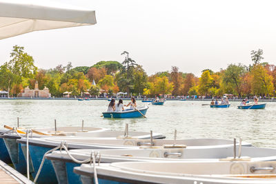 Boats in river against clear sky