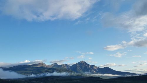 Scenic view of mountains against cloudy sky