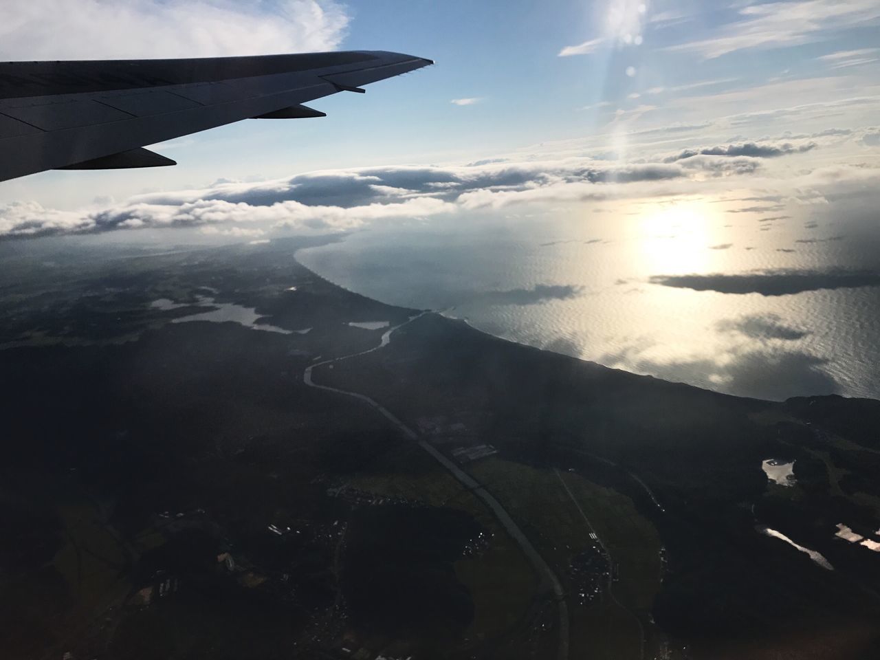 AERIAL VIEW OF AIRCRAFT WING OVER MOUNTAINS