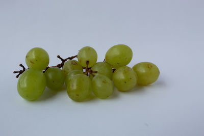 Close-up of grapes over white background