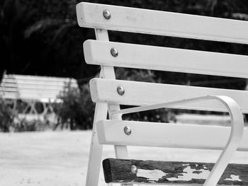 Close-up of empty bench in park