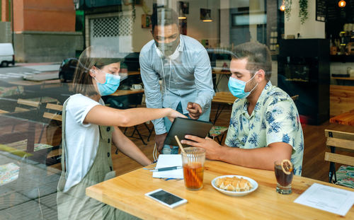 Young business people at an informal business meeting in a coffee shop