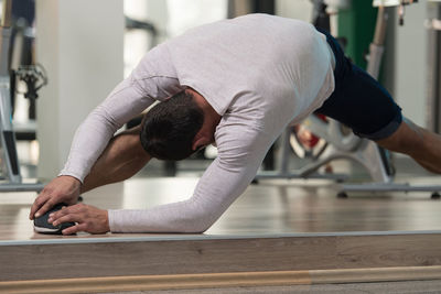 Muscular man exercising in gym