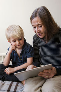 Grandmother and grandson using digital tablet