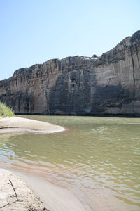 Scenic view of cliff against clear sky