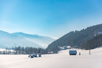 Snow covered mountains against blue sky