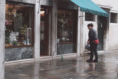 Full length of man standing by window in building