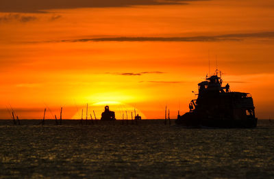 Silhouette sailboat on sea against sky during sunset