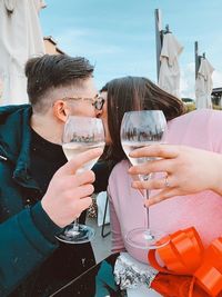 Portrait of a smiling young woman drinking glass