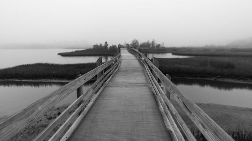 Pier over lake against sky